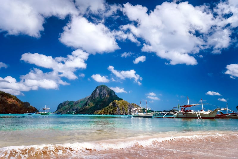 El Nido bay with boats on the beach and Cadlao island, Palawan, Philippines